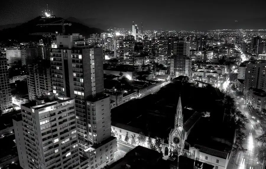 Stand-up comedy in Chile: Santiago at night from above, its towers and avenues lit beneath the hills