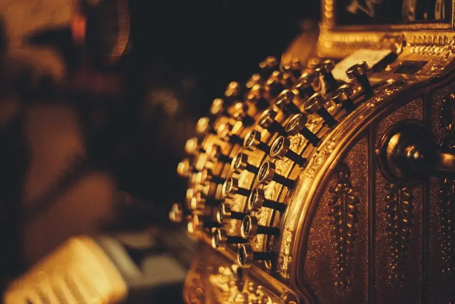 An antique brass cash register in amber light: exposure gigs