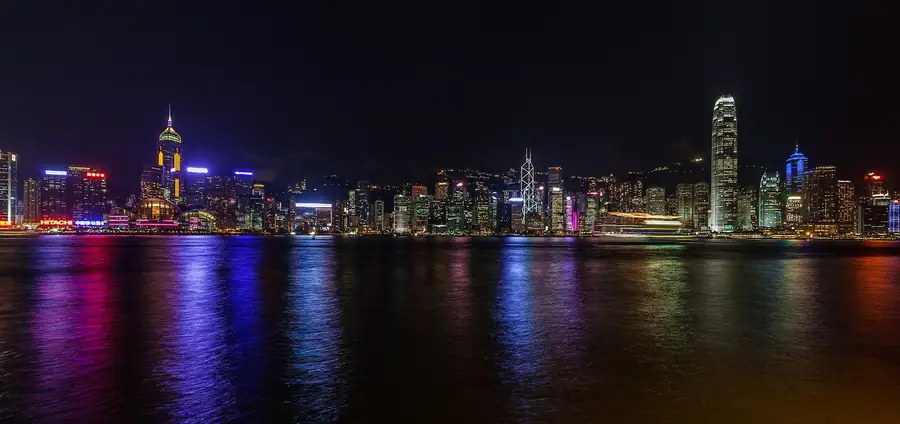 Stand-up comedy in Hong Kong: the skyline of Hong Kong Island lit up across Victoria Harbour at night, seen from Kowloon