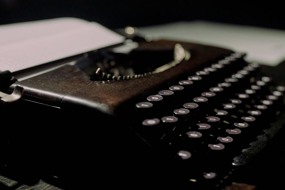 An enhanced listing waiting for your words: an old typewriter in the dark with a blank sheet loaded
