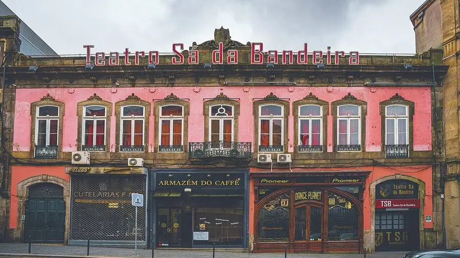 The pink front of the Teatro Sá da Bandeira on rua de Sá da Bandeira, Porto, its name in red letters along the roof